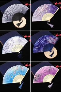 Multiple colors of traditional cherry blossom folding fans with decorative tassels