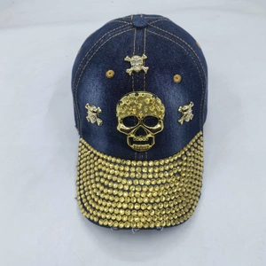 Deep blue washed denim baseball cap with gold skull emblems and studded brim