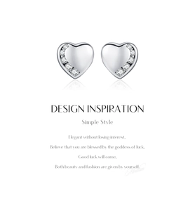 Macro detail of silver heart stud earrings featuring polished finish and zircon accents