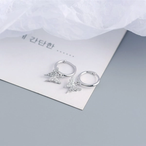 Macro detail of S925 sterling silver butterfly earrings with sparkling cubic zirconia pavé