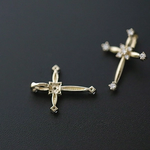 Macro shot of gold S925 sterling silver cross pendants with shimmering zircon stone inlays