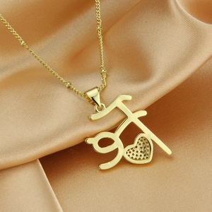 Macro shot of 18k gold plated heart necklace with Hindi Maa text and micro crystals