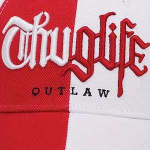 Detailed macro view of the two-tone cotton cap featuring gothic Thug Life embroidery
