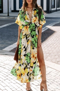 Detail of bohemian floral maxi dress featuring a deep V-neck and high leg slit design