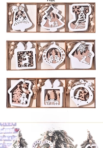 Detail of laser-cut wooden Christmas ornaments with snowflake and reindeer patterns