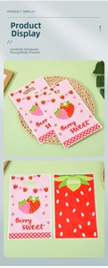 Close-up of strawberry gift bags with Berry Sweet text and decorative leaf handle design