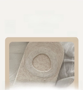 Close-up of wide ribbed elastic cuff on beige low-cut invisible cotton socks for women
