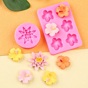 Pink silicone camellia and lily flower cake molds with realistic floral fondant shapes