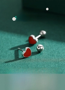 Macro detail of red enamel heart stud earrings with secure silver screw back closures