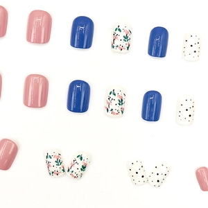Pink and blue press-on nails with floral and polka dot patterns in short square shape