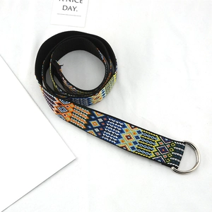 Close-up of ethnic canvas belt with colorful geometric patterns and silver D-ring buckle