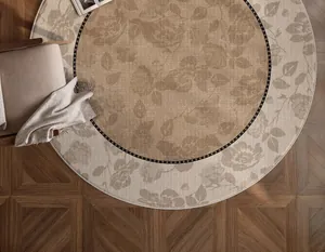Detail of round vintage floral rug with cream finish on walnut parquet flooring