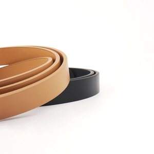 Close-up of black and brown vintage PU leather belts with polished edges for dresses