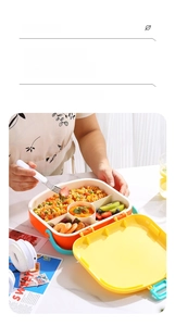 Detail of multi-compartment portable lunch box filled with pasta and fruits in use
