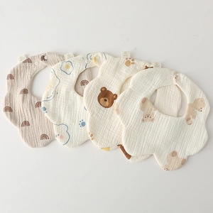 Detail of four-piece soft cotton gauze baby bibs with cute bear and rainbow prints