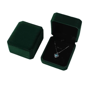 Dark green velvet octagonal jewelry boxes for necklace storage with a silver heart pendant