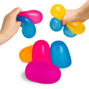 Close-up of hand squeezing colorful rainbow candy slow rebound stress relief toy