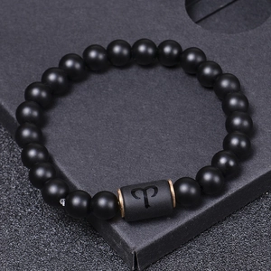 Matte black onyx Aries constellation beaded bracelet on a premium textured gift box