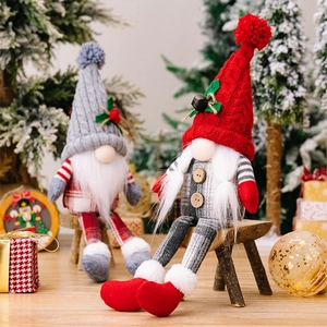 Detail of Christmas gnomes with knitted hats and faux fur beards on a wooden stool