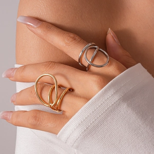 Detailed view of layered geometric circular rings in gold and silver finish on hand