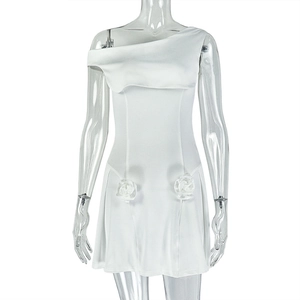 Detail of white one-shoulder mini dress featuring fabric rose embellishments at the waist