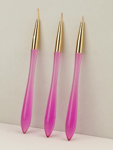 Detail of three nail art liner brushes with pink transparent drop-shaped resin handles