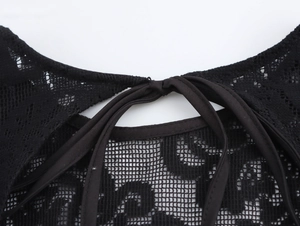 Détails rapprochés de la dentelle au dos et du lacet sur la robe noire sexy