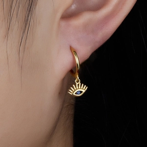 Elegant gold S925 sterling silver evil eye earrings with blue gemstone on model