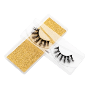 Detailed close-up of 3D faux mink eyelashes with thick natural curls and golden card