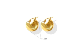 Detail view of 18K gold-plated C-shape hoop earrings with a 1.9cm diameter and textured finish