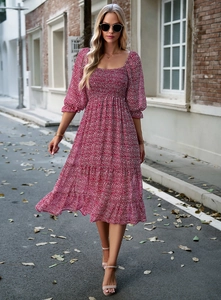 Close-up of red floral square-neck dress with puff sleeves and ruffled hem on city street