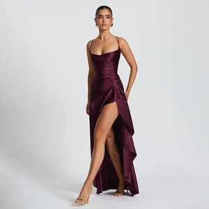 Detail of elegant dark purple satin maxi dress featuring a high slit and ruffled design