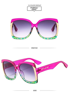 Detail view of square oversized sunglasses with purple gradient frame and green accents