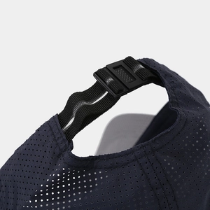 Detail of adjustable black plastic buckle and breathable navy mesh on outdoor sports cap