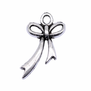 Antique silver metal bow pendant for DIY jewelry making with textured finish on white background