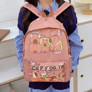 Pink cartoon Capybara print backpack for kids on wooden bookshelf background