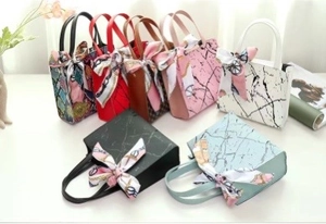 Detailed display of large capacity handbags with silk scarves in various patterns and colors