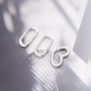 Detailed macro view of S925 silver heart and oval spring clasps for jewelry making