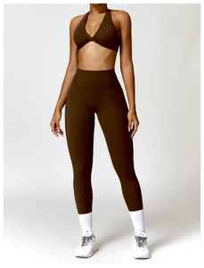 Detail of chocolate brown yoga set showing cross-back sports bra and high-waist leggings