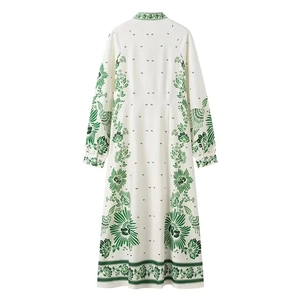 Detail view of the back of a white floral maxi dress with green prints and lantern sleeves