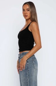Close-up of black ribbed knit camisole top showing detailed texture and slim fit design