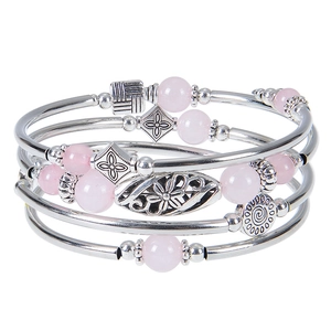 Bohemian multi-layer silver bracelet with pink beads and floral metallic pendants