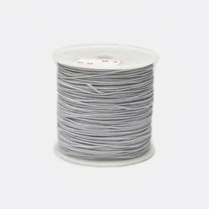 Detailed view of 1.2mm gray braided cord wound on a white spool for jewelry making