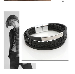 Detail view of men's layered black leather bracelet with silver magnetic metal clasp
