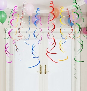 Close-up of colorful metallic PVC swirl decorations hanging from a party ceiling