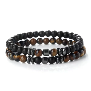 Tiger eye and matte onyx beaded bracelet set with grey metal spacers on white background