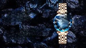 Detail of blue gradient dial with diamond-cut glass and rose gold steel strap watch