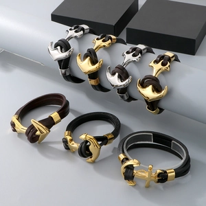 Detail of vintage anchor bracelets featuring layered leather straps and polished metal clasps