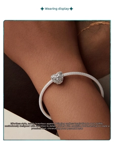 Detailed close-up of S925 sterling silver hollow heart charm with leaf pattern on a snake chain
