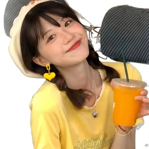 Elegant yellow heart-shaped acrylic earrings worn by a model in a bright casual outfit